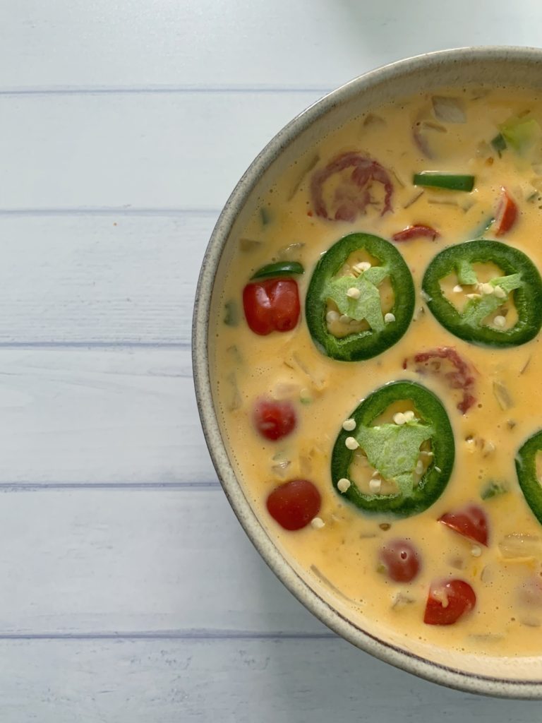 An Authentic Easy Queso Dip Recipe featured by top US food blog, Food Diary of a City Girl: image of a bowl with queso dip.