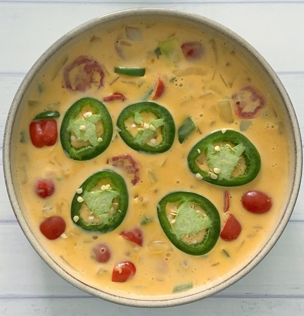 An Authentic Easy Queso Dip Recipe featured by top US food blog, Food Diary of a City Girl: image of a bowl with queso dip.