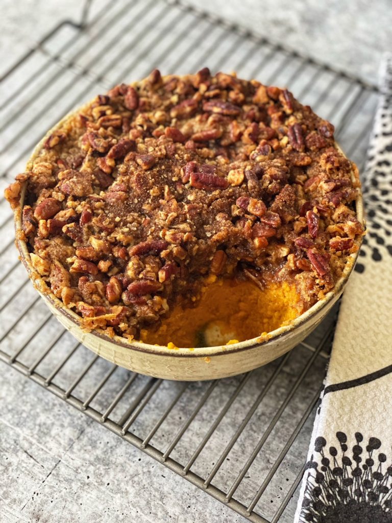 Sweet Potato Casserole recipe with Pecans Topping featured by top US food blogger, Food Diary of a City Girl: image of Sweet Potato Casserole served on North Carolina's HAAND Pottery.